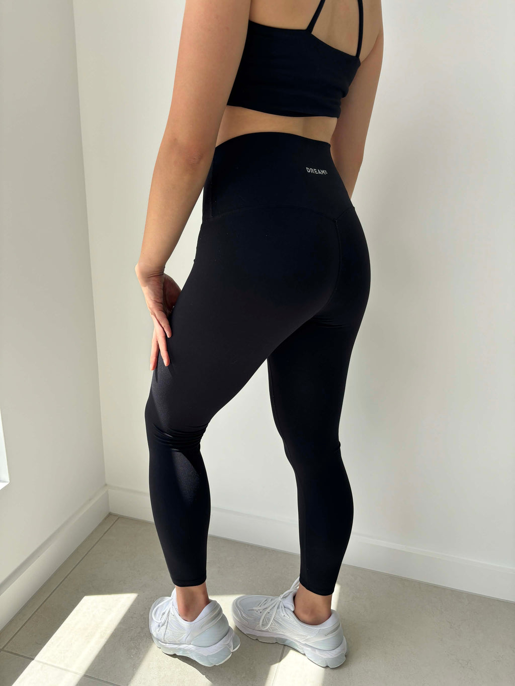 Wearing black leggings by DREAMR Australia