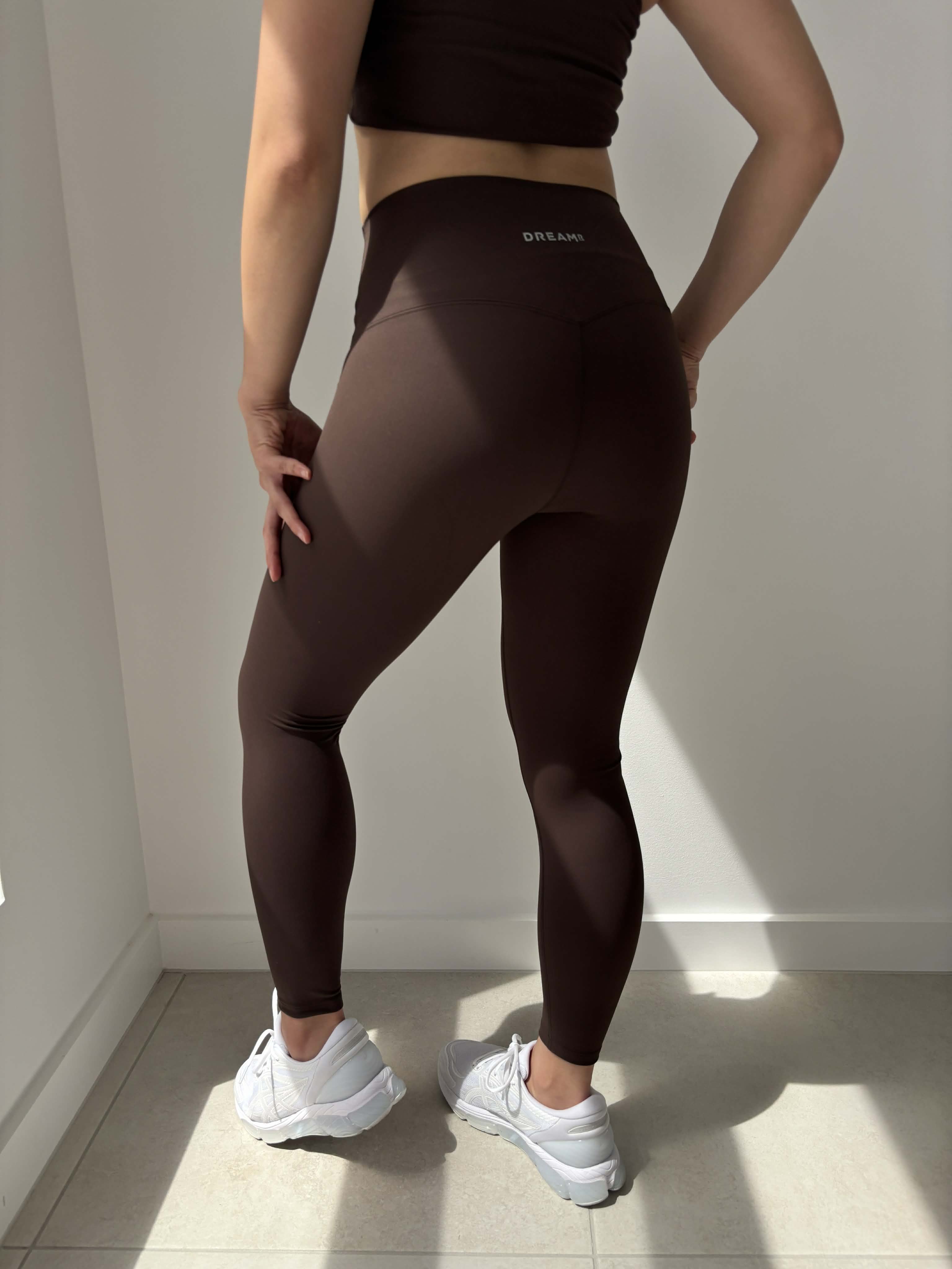 Person wearing brown high waisted affordable legging designed by DREAMR Australia